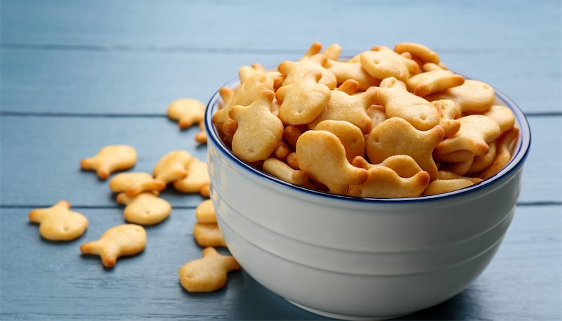 Goldfish crackers scattered on surface showing sticky snack foods that cause cavities in Chattanooga children